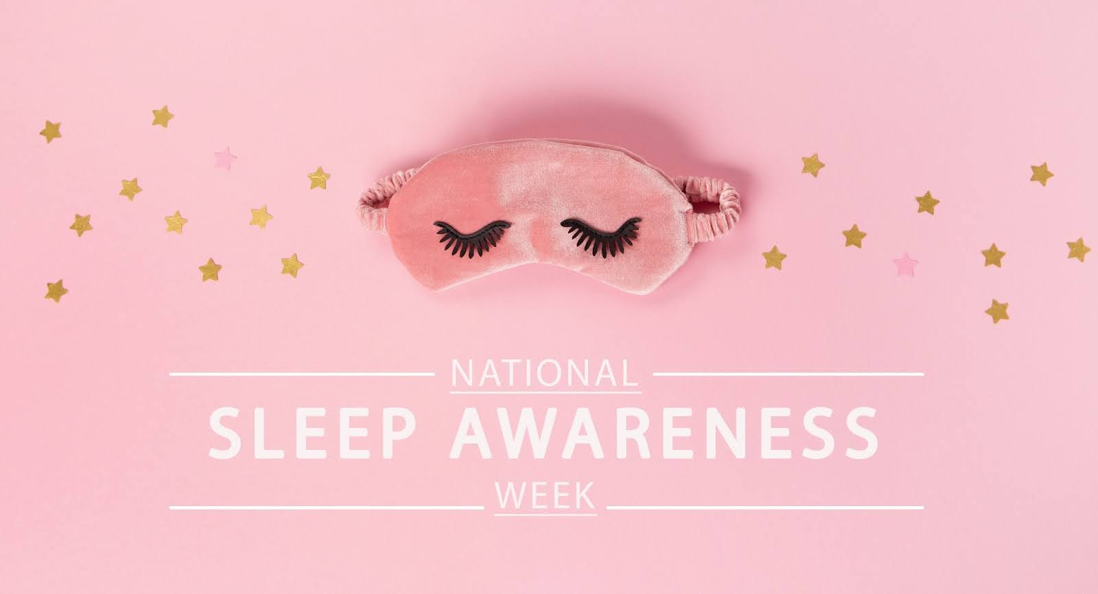 A pink sleep mask on a pink background with stars.